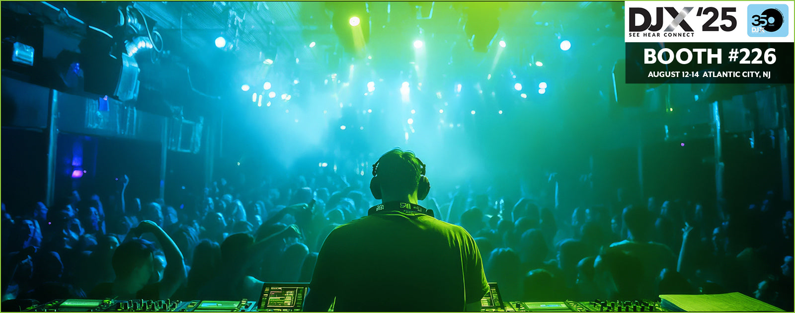 DJ at a concert with a crowd and event branding in the background